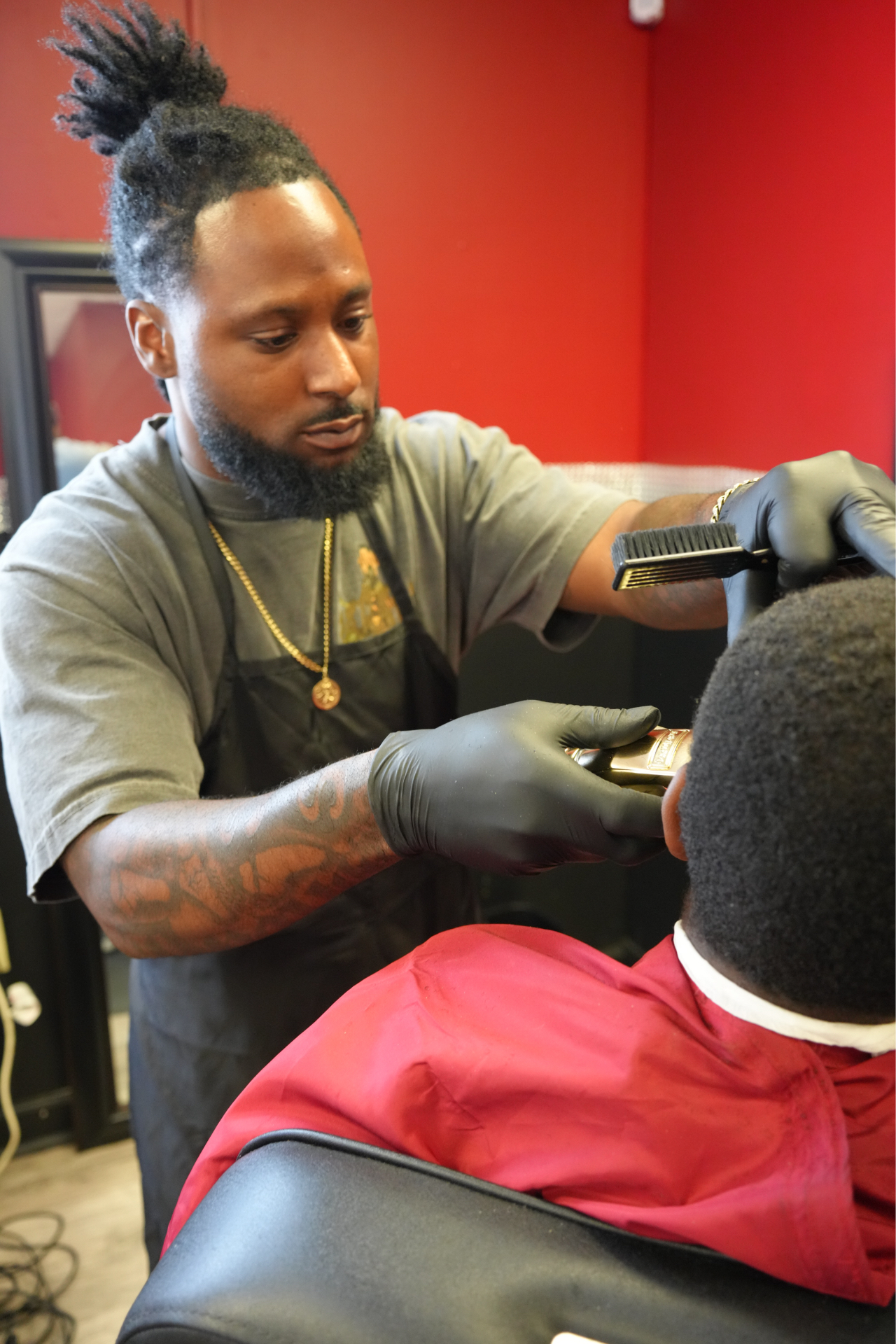Tre', barber at 7 Fadez Barbering, cutting a client's hair